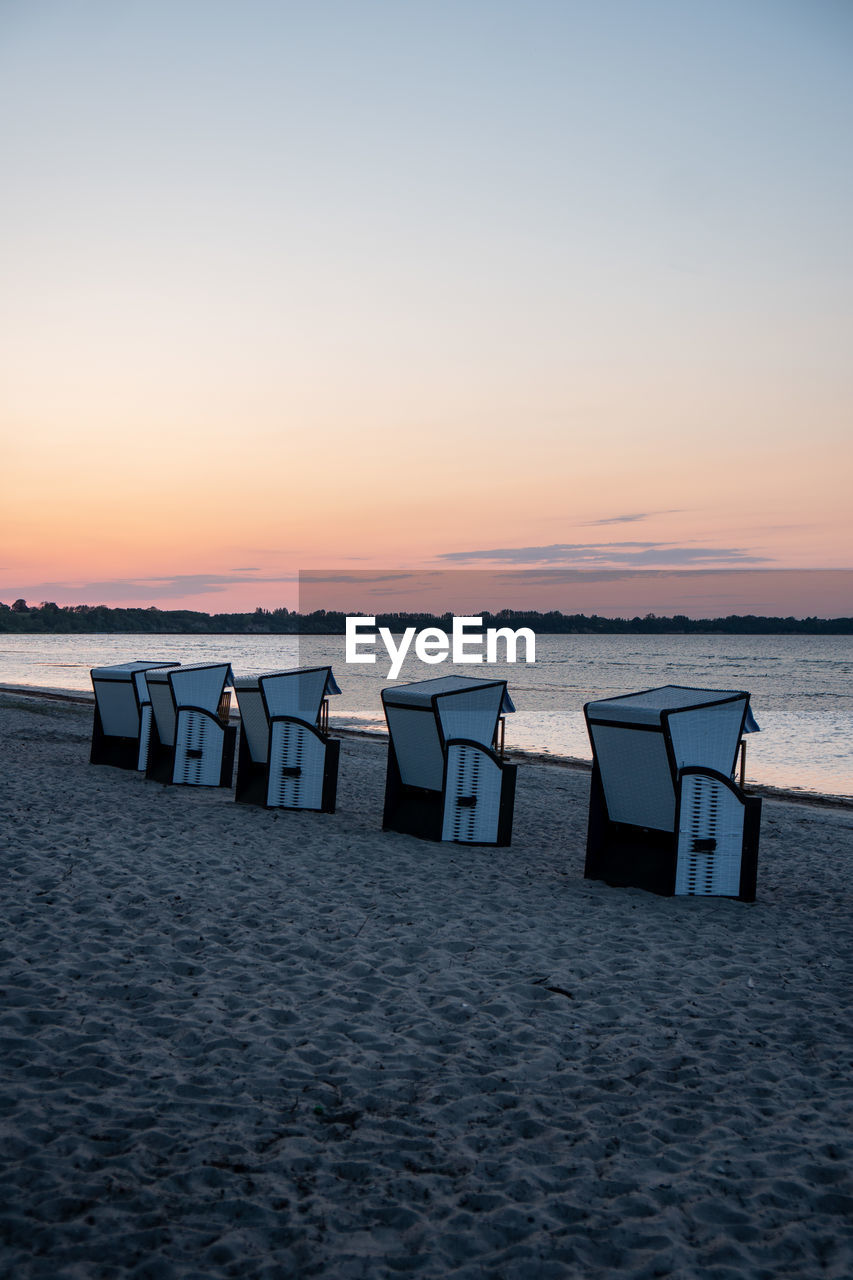 SCENIC VIEW OF BEACH AT SUNSET