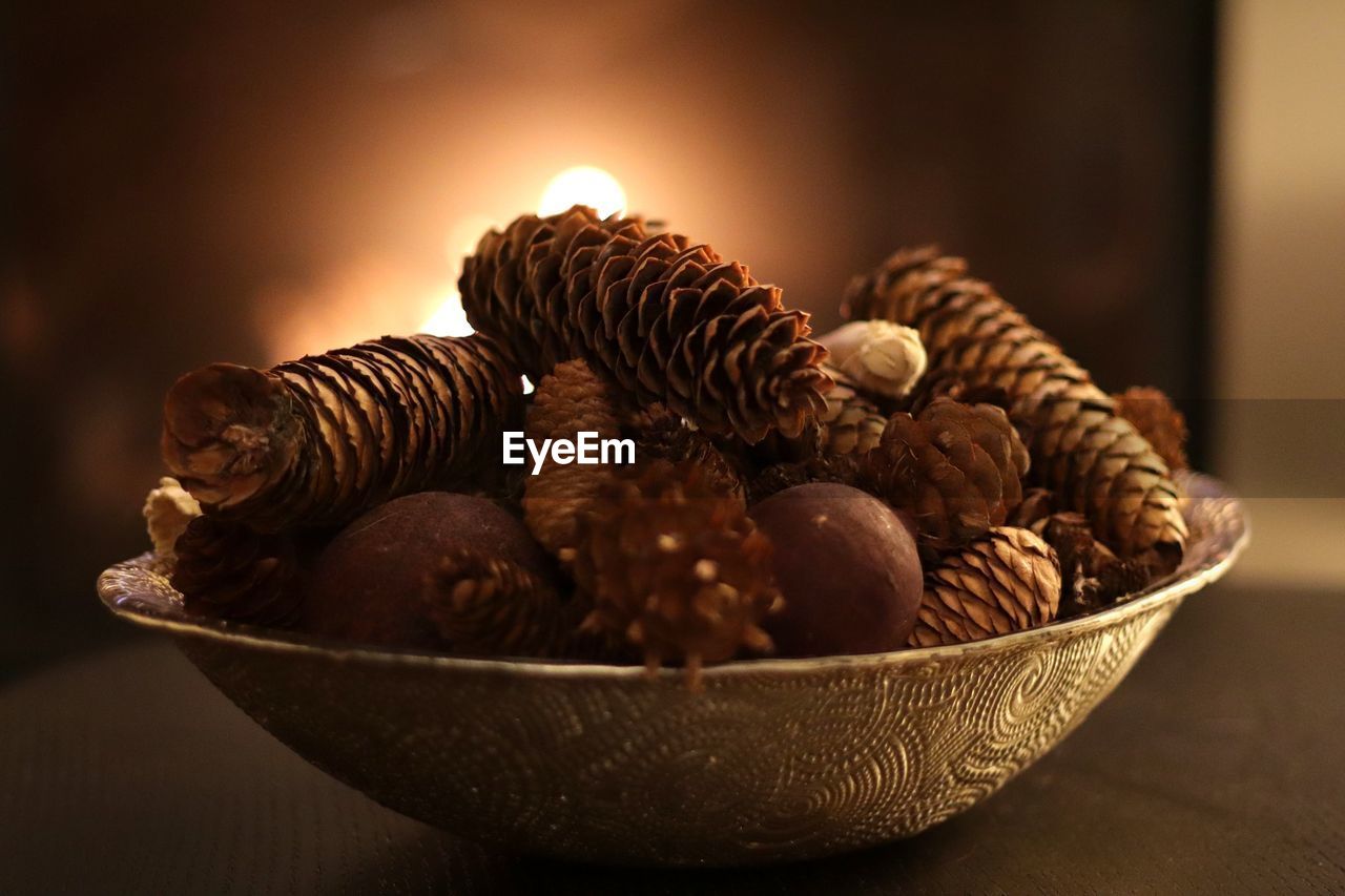 Close-up of pine cones in bowl on table