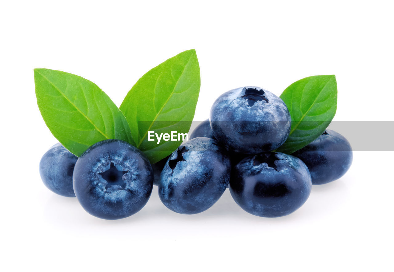 CLOSE-UP OF FRESH FRUITS AGAINST WHITE BACKGROUND