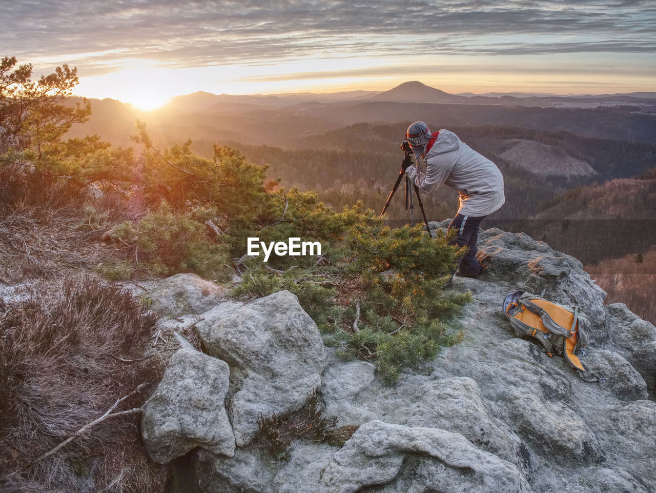 Photographer taking picture. woman artist photo enthusiast stay with camera above valley and works