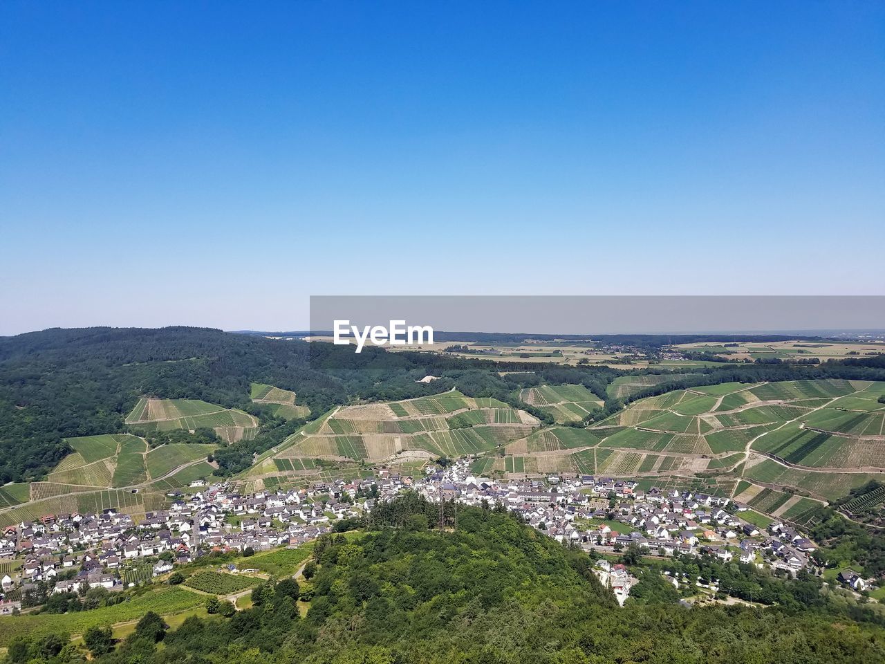 High angle view of townscape against clear blue sky