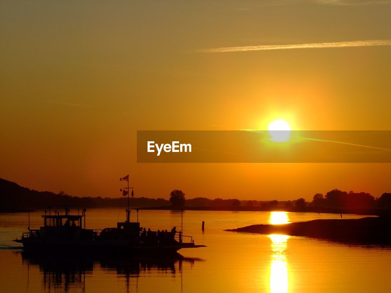 SILHOUETTE BOATS IN SEA AGAINST ORANGE SKY DURING SUNSET