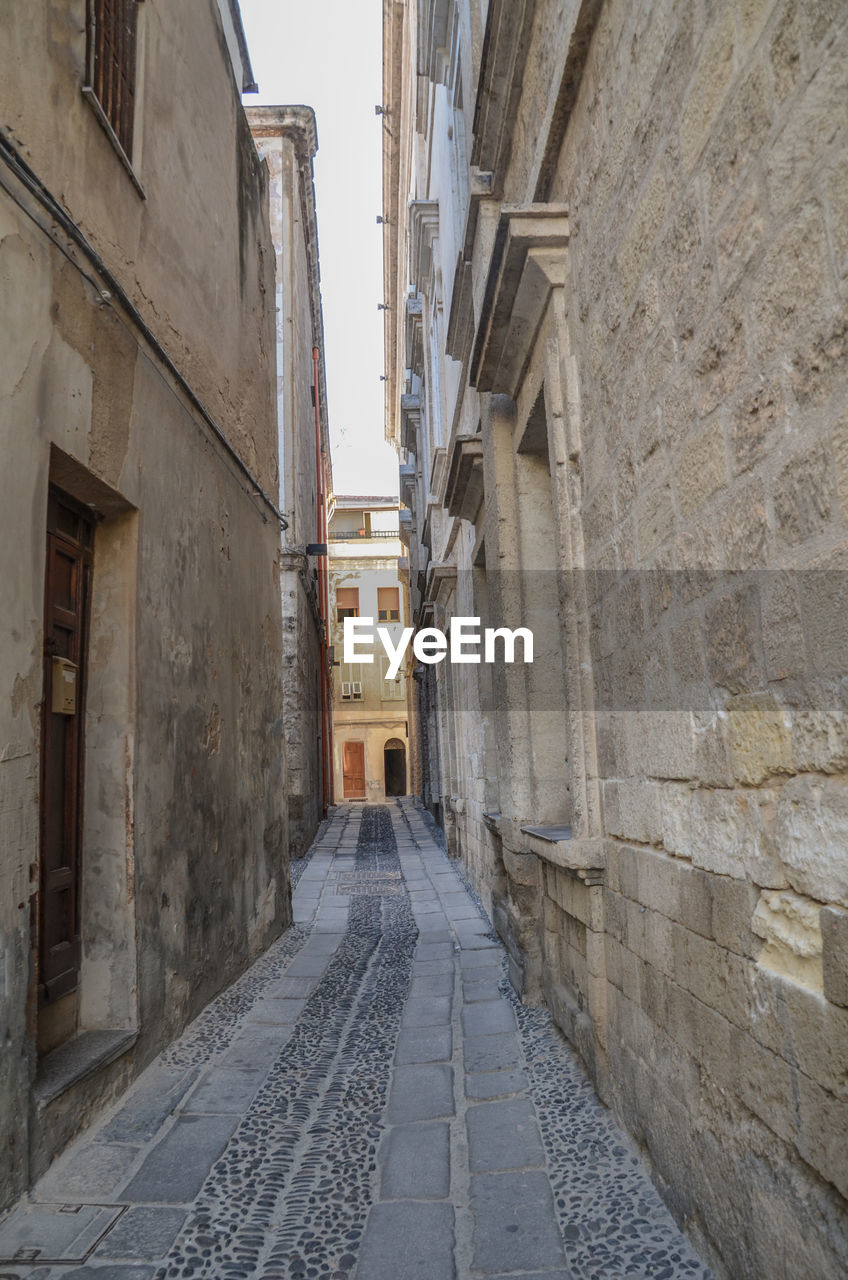 Empty alley amidst buildings in city