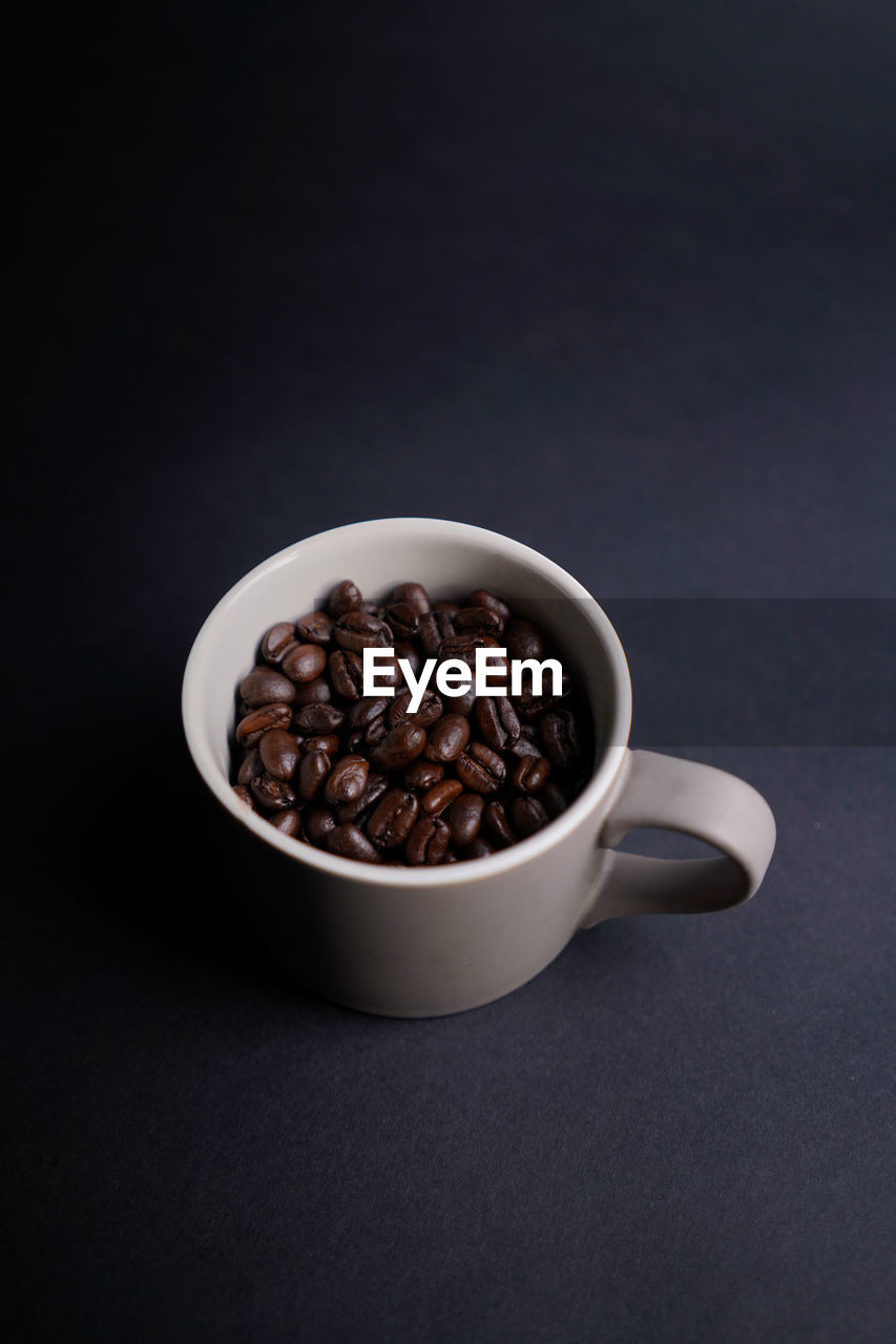 CLOSE-UP OF COFFEE BEANS ON TABLE