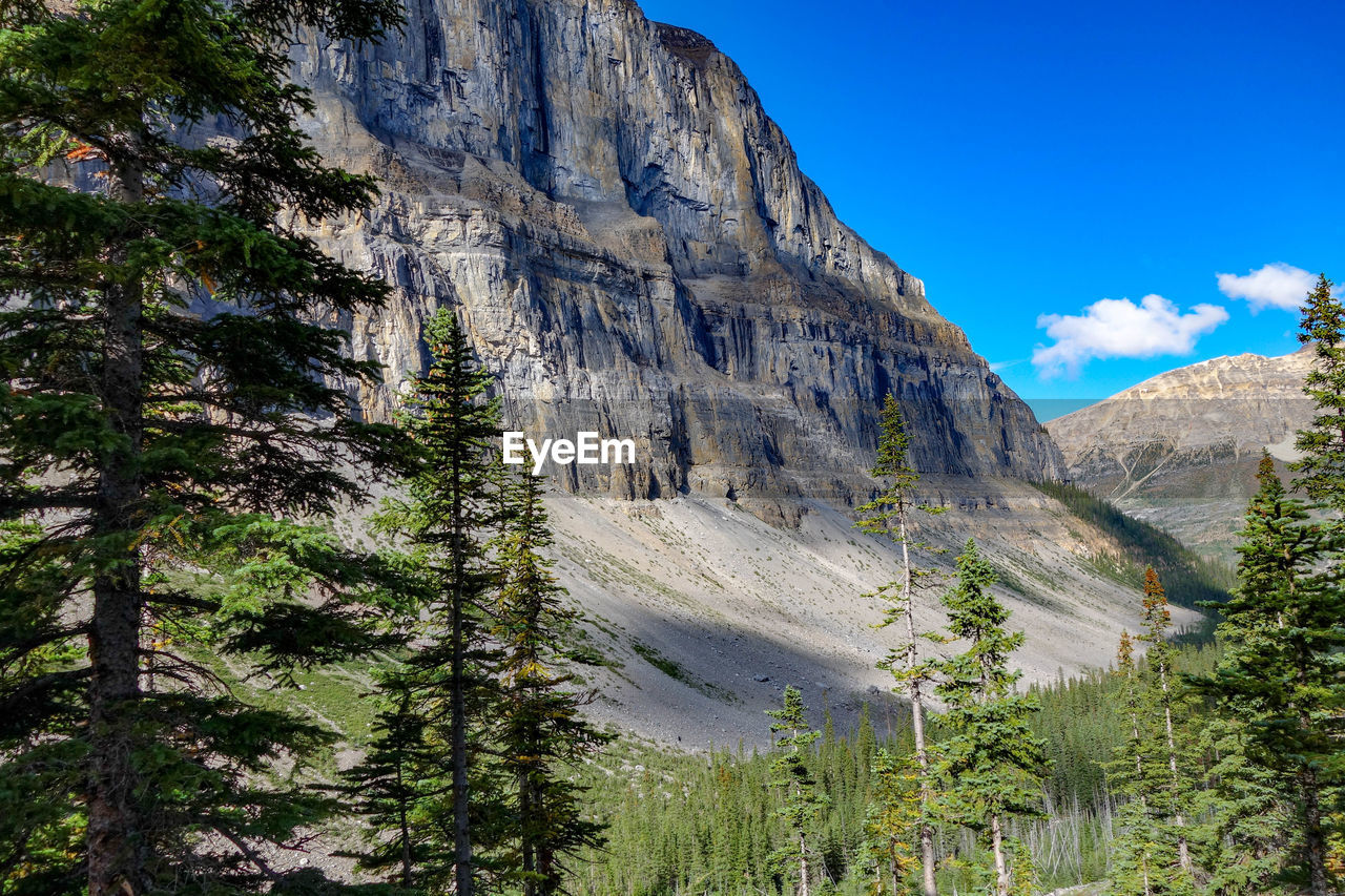 Low angle view of rocky mountains against sky