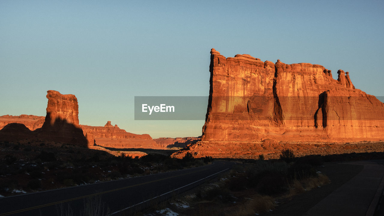 Sunrise shining on rock formation.