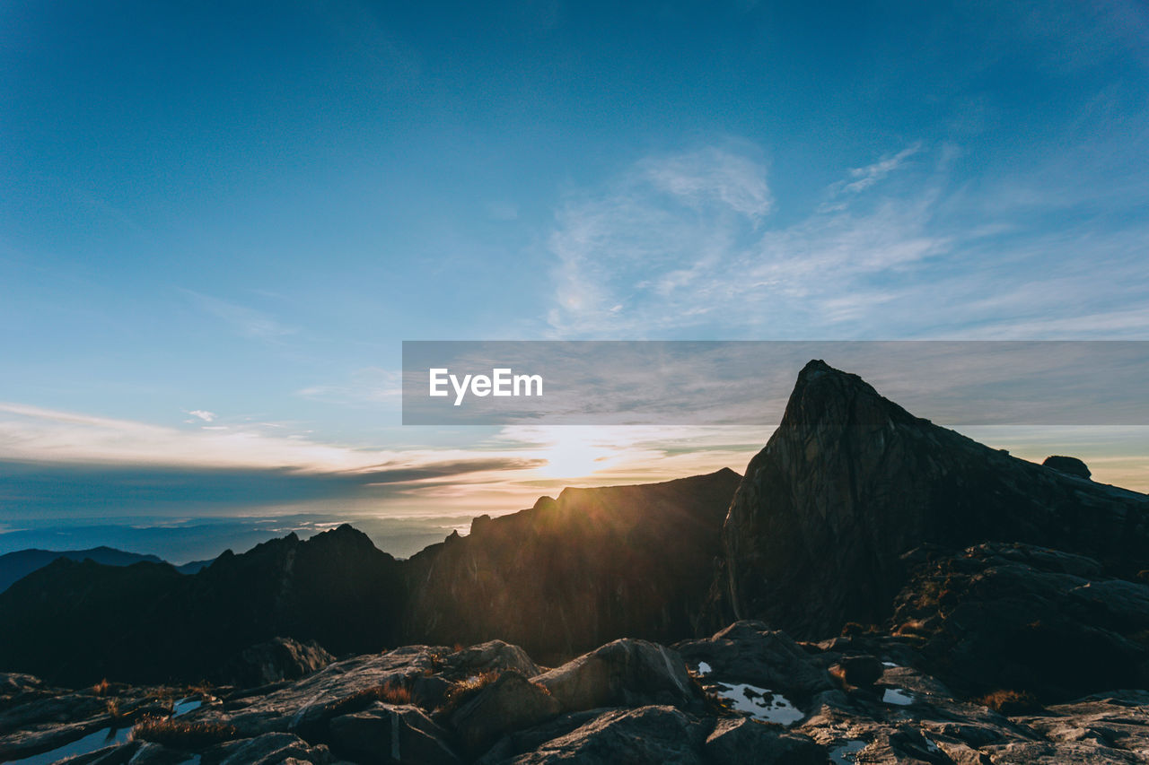 SCENIC VIEW OF SNOWCAPPED MOUNTAIN AGAINST SKY DURING SUNSET