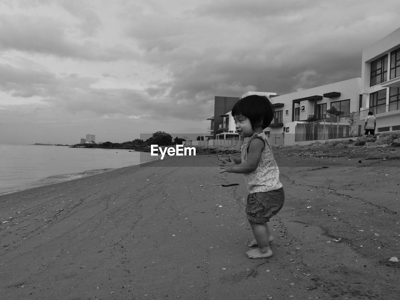 Side view of girl standing on sand at beach