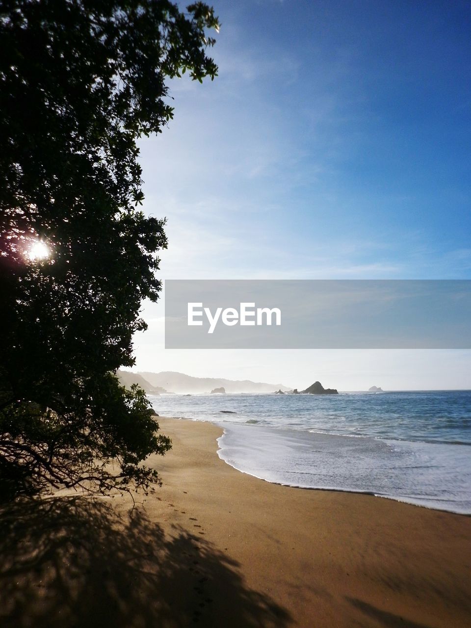 Idyllic view of beach against sky