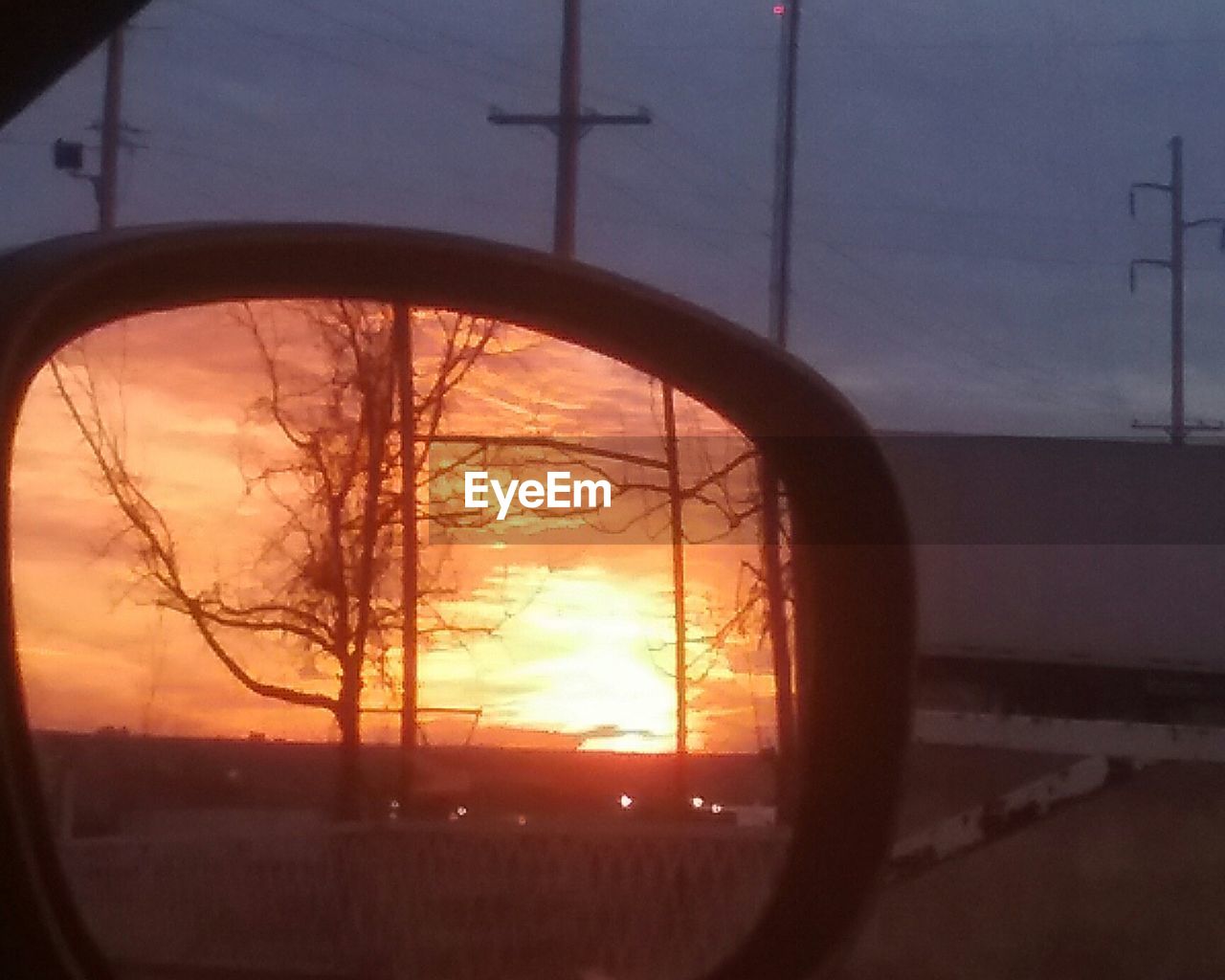 CLOSE-UP OF CAR WINDOW AGAINST SKY