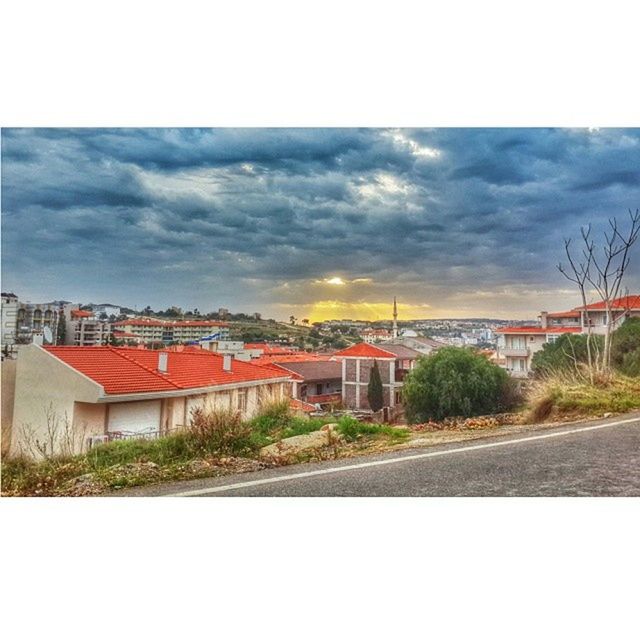 ROAD WITH CLOUDY SKY IN BACKGROUND