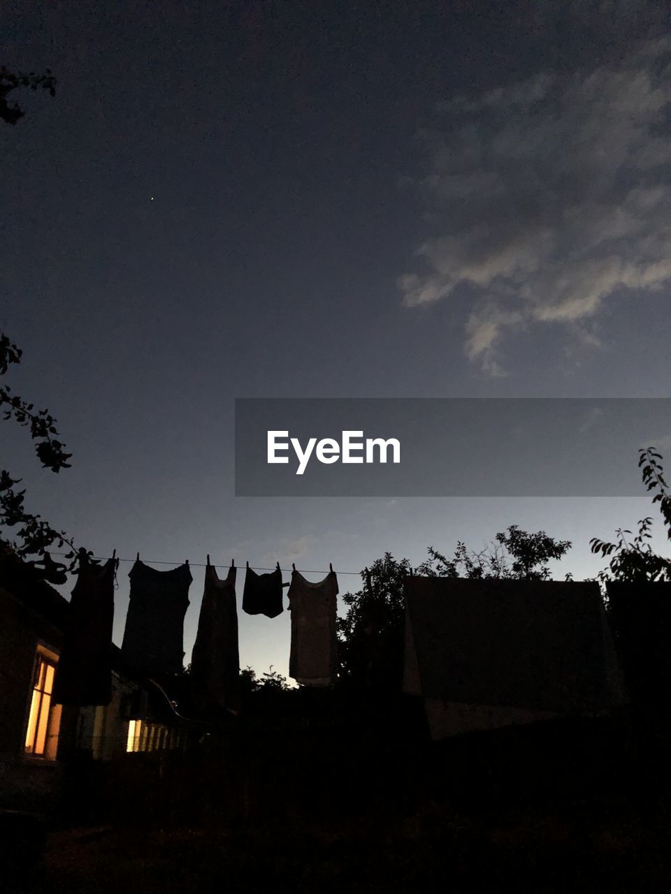 Low angle view of silhouette buildings against sky at night