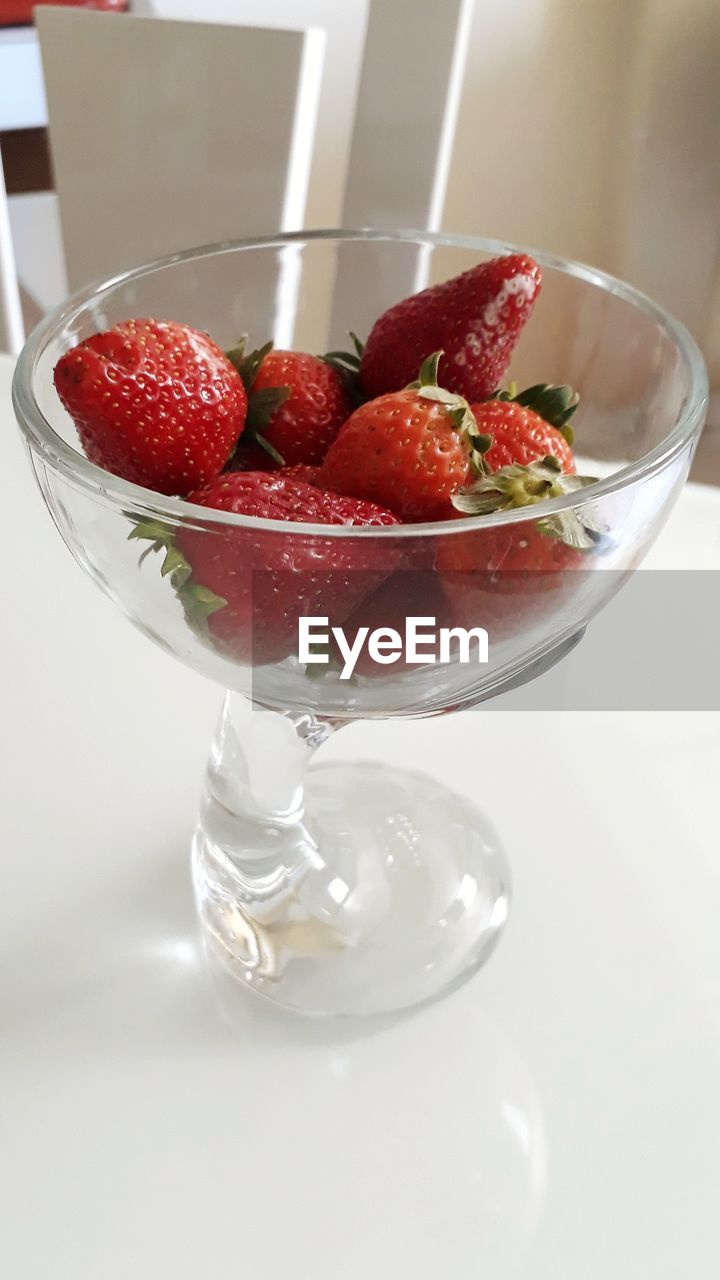 CLOSE-UP OF STRAWBERRIES IN GLASS