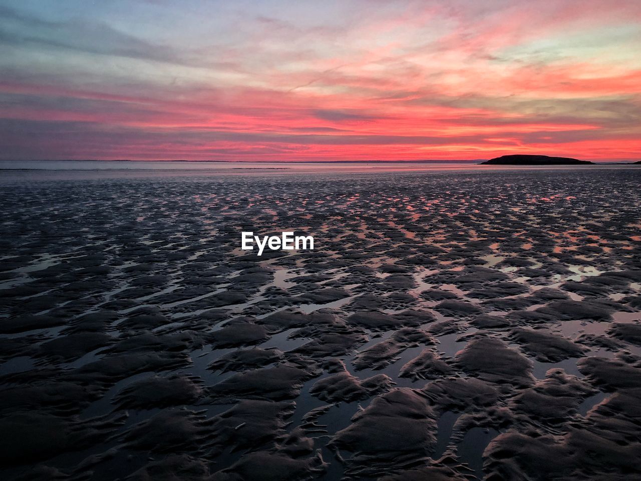 Scenic view of beach against sky during sunset