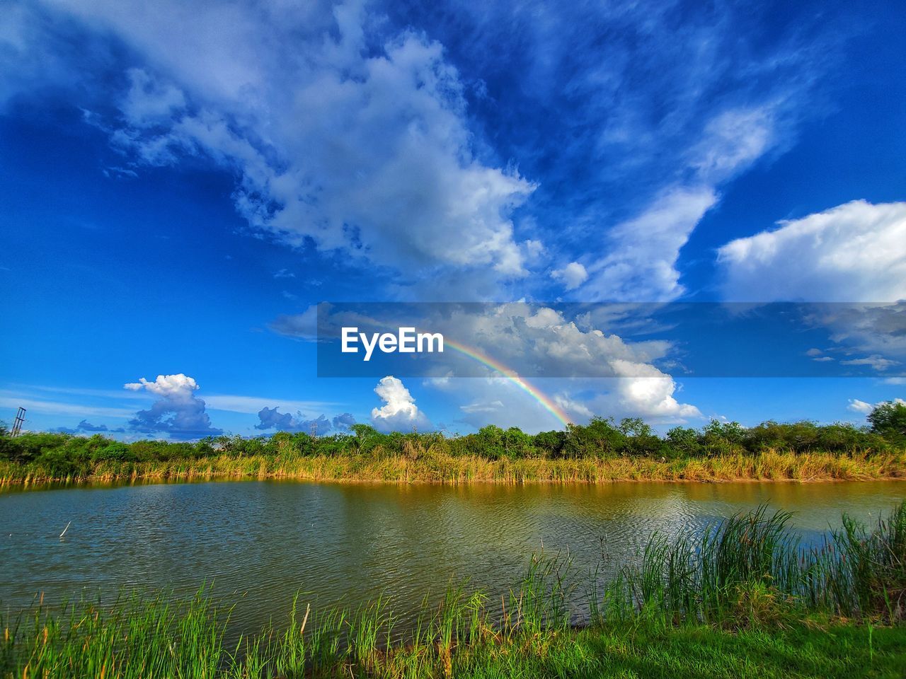 Scenic view of lake against blue sky