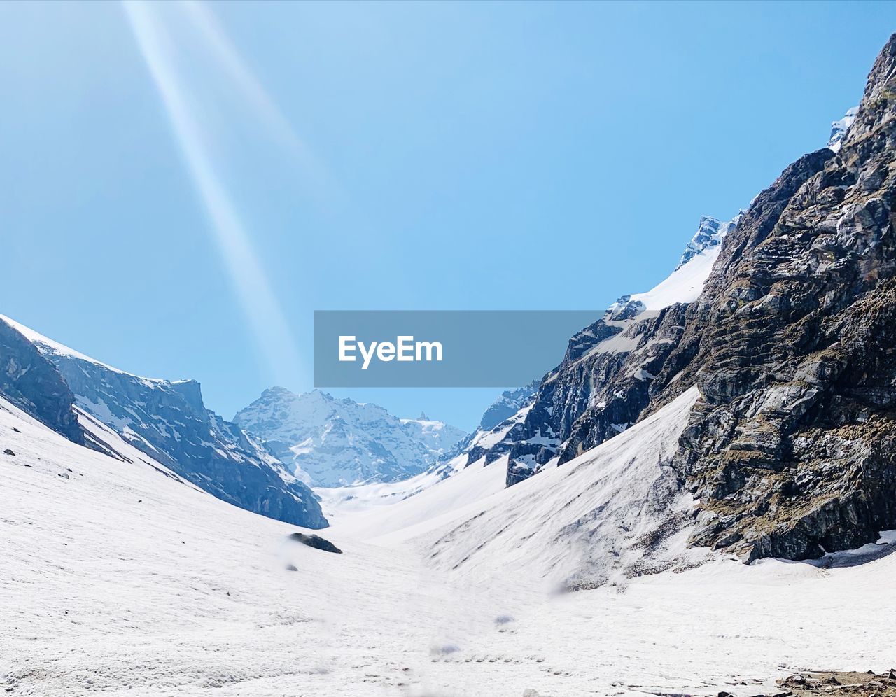 Scenic view of snowcapped mountains against sky