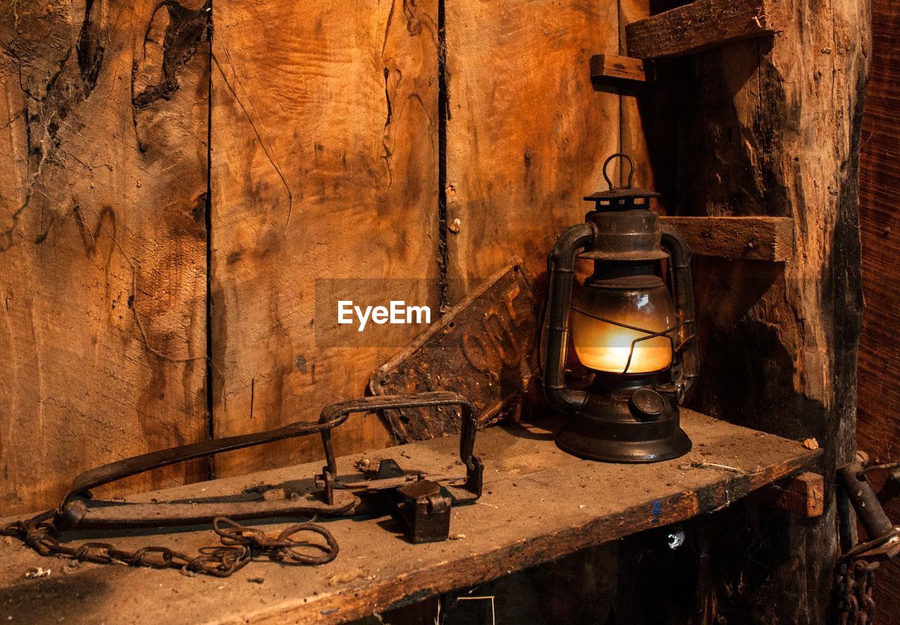 Old-fashioned lantern on wooden table