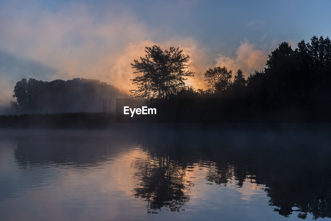 Scenic view of lake against sky during sunset