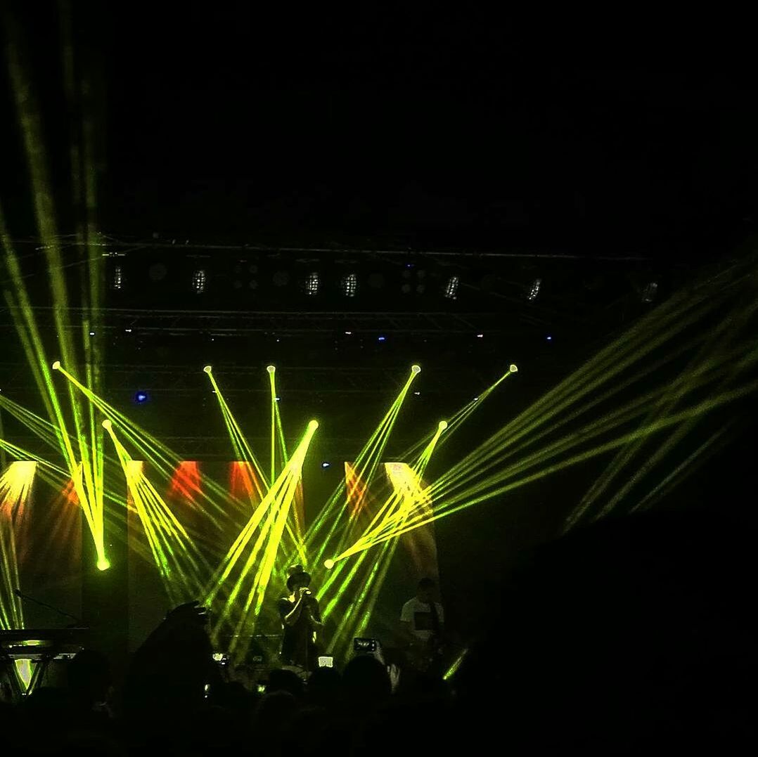 CLOSE-UP OF ILLUMINATED STAGE AT NIGHT