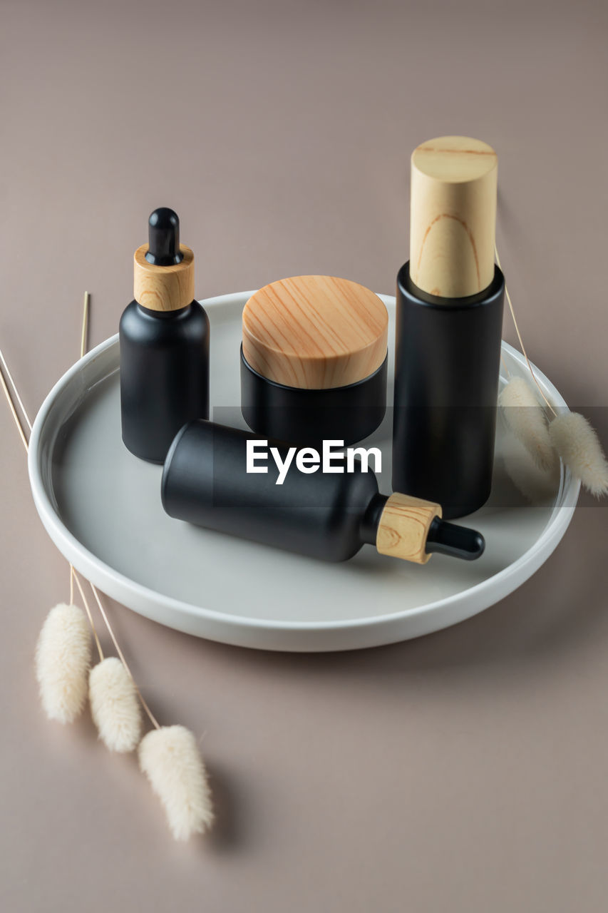 Set of natural organic cosmetics on ceramic tray. face moisturizer cream in eco friendly bamboo jar