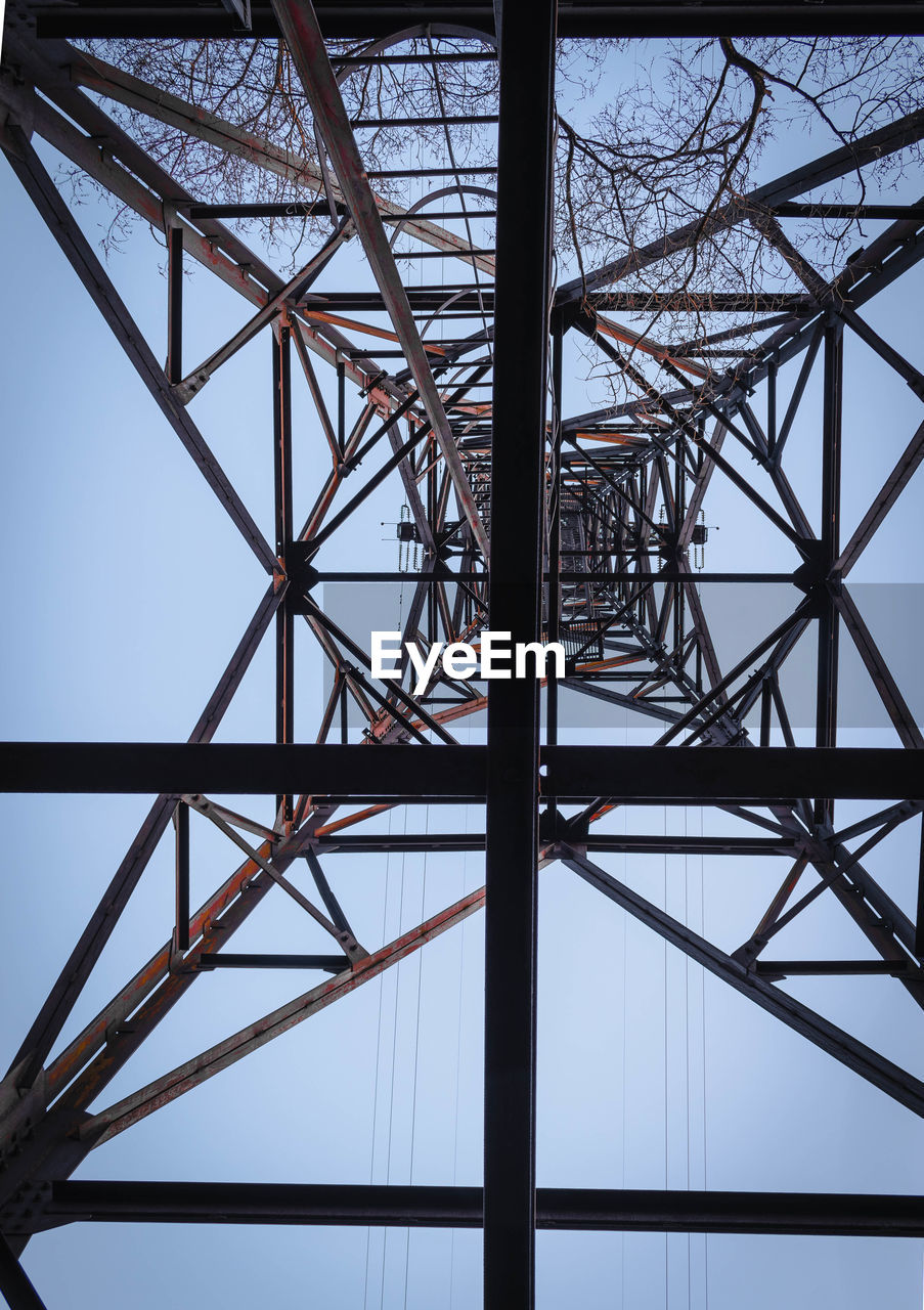 Low angle view of electricity pylon against sky