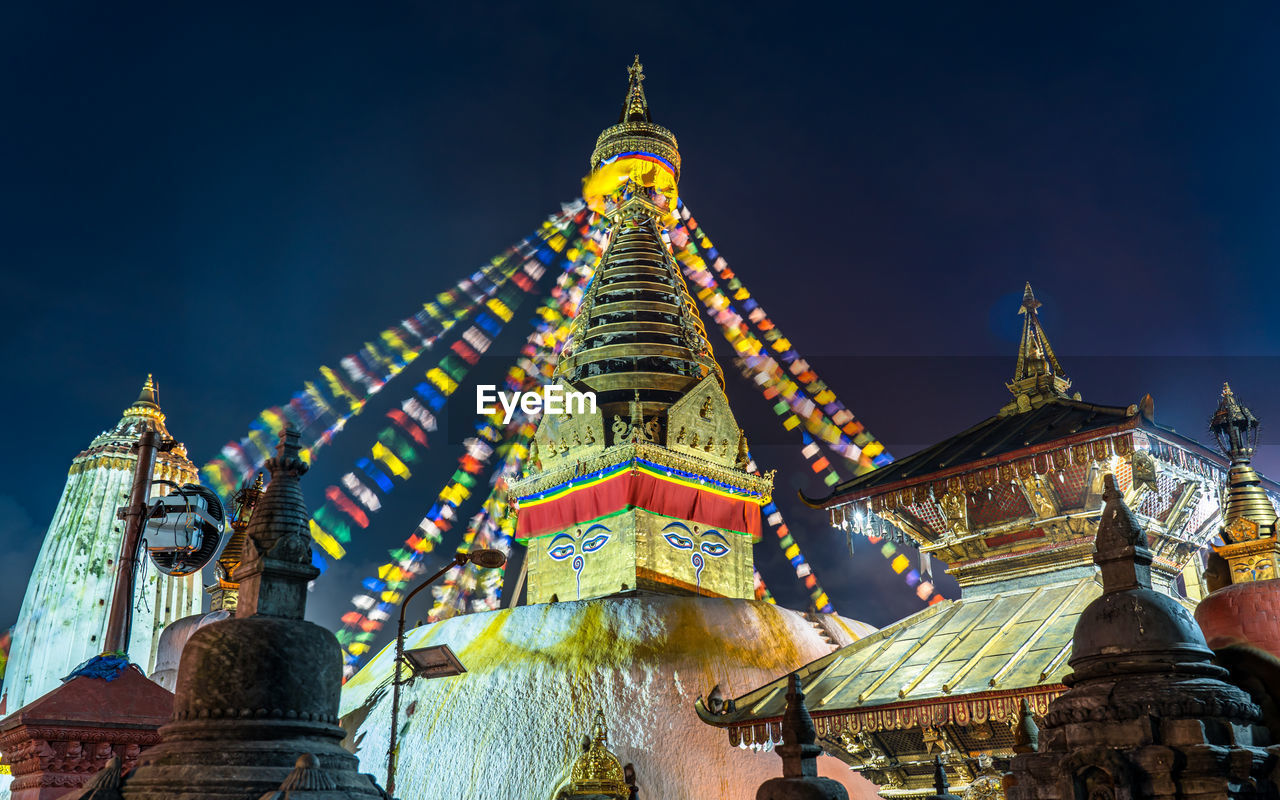 architecture, religion, belief, temple - building, travel destinations, built structure, building, travel, building exterior, spirituality, sky, history, landmark, temple, the past, place of worship, pagoda, nature, tourism, ancient, tradition, culture, tower, no people, city, outdoors, multi colored, night, decoration, blue, environment, business finance and industry, landscape
