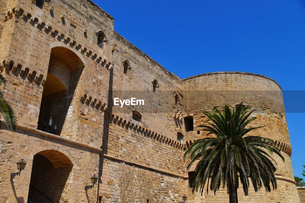 Low angle view of historical building against blue sky