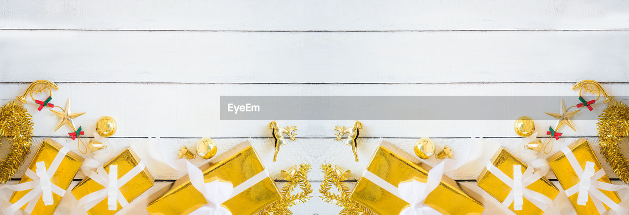 LOW ANGLE VIEW OF YELLOW DECORATION HANGING ON WALL