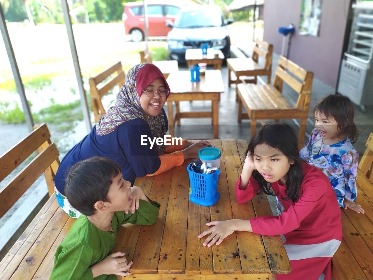 High angle view of family sitting at restaurant