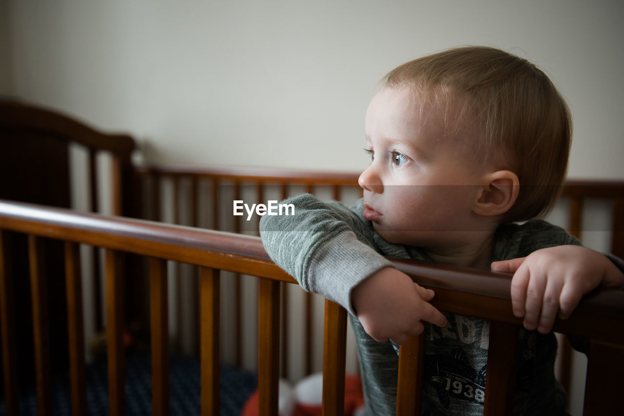 Close-up of baby boy in crib