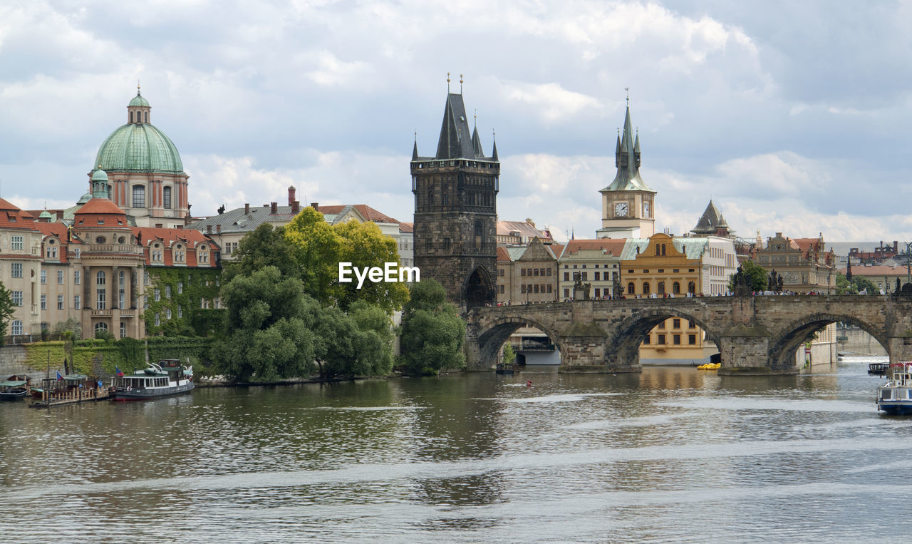 BRIDGE OVER RIVER AGAINST BUILDINGS