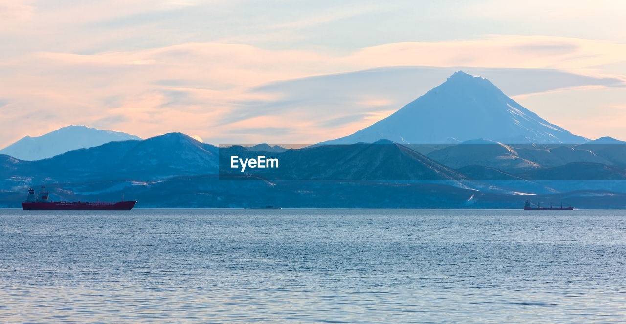 The fishing boats in the bay with the volcano on kamchatka