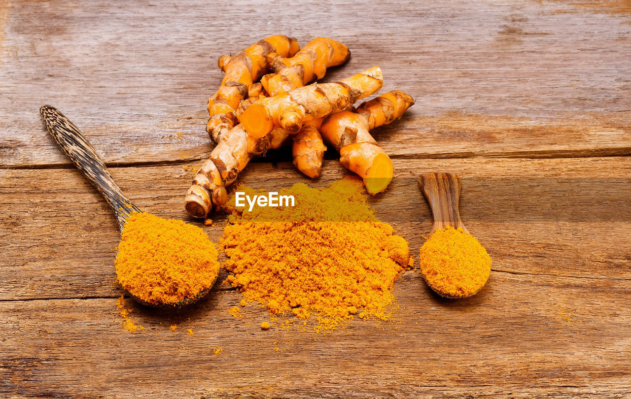 Close-up of turmeric on wooden table