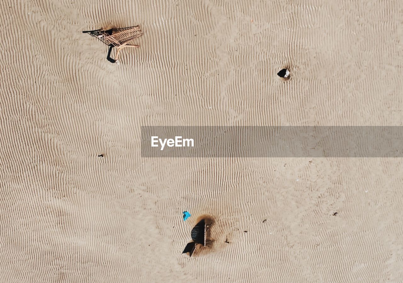 High angle view of shopping cart on sand