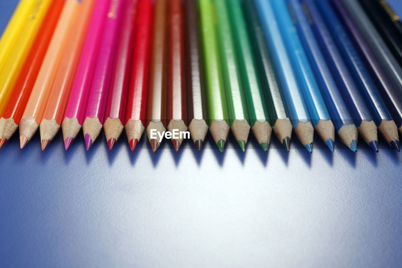 Close-up of colorful colored pencils on table