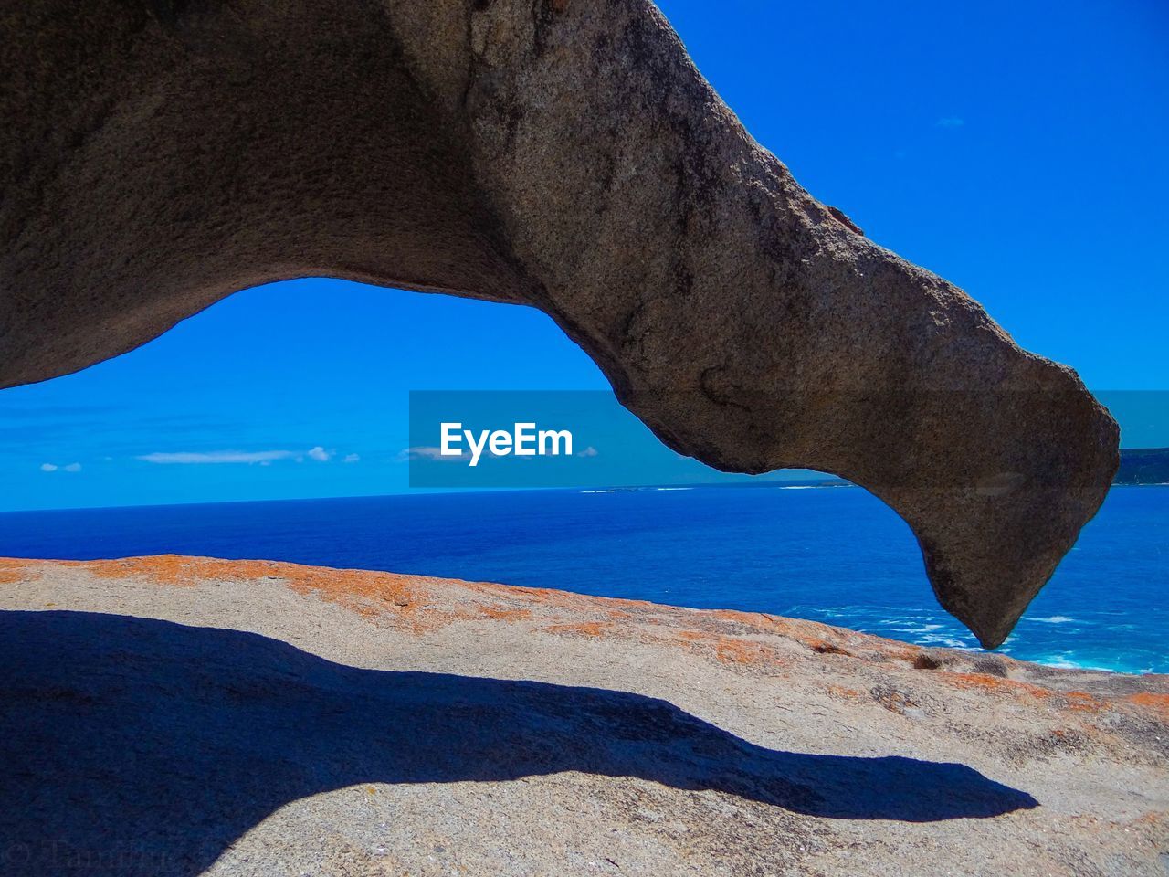 Scenic view of beach against blue sky