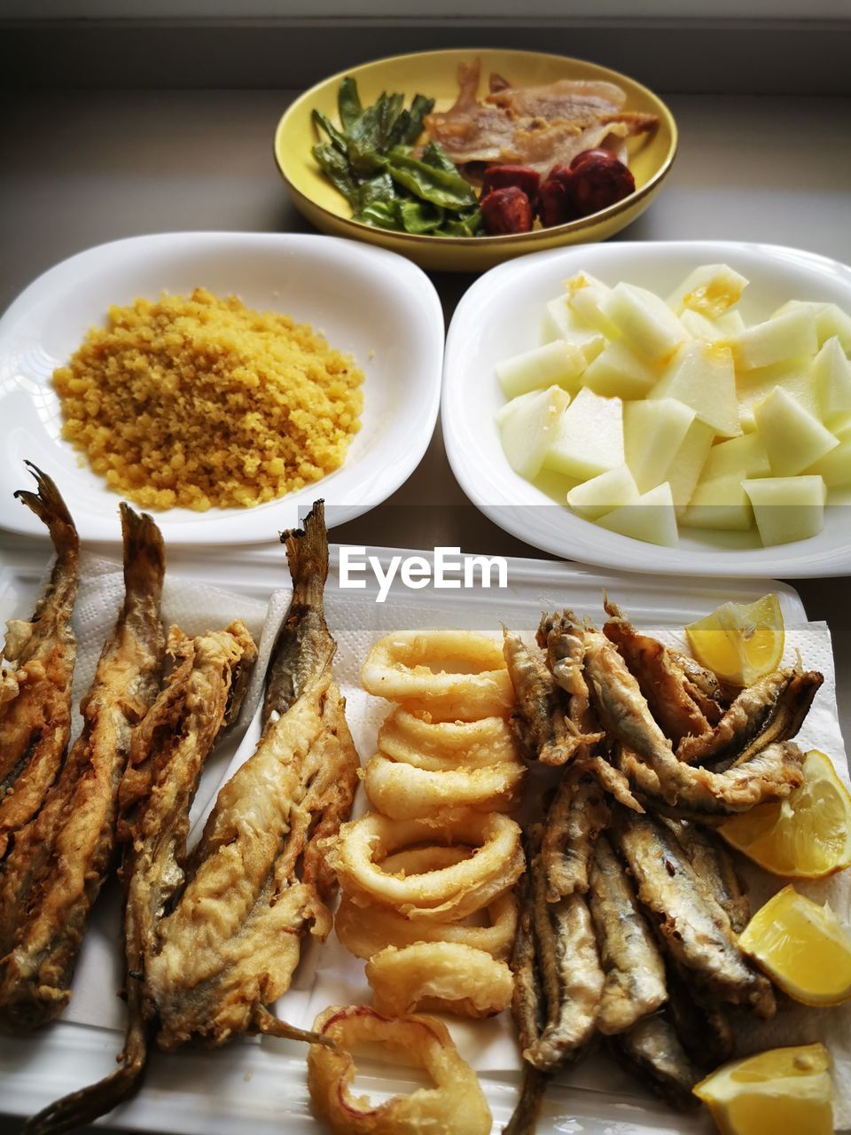 food, food and drink, freshness, healthy eating, plate, dish, fish, no people, meal, vegetable, wellbeing, cuisine, indoors, fried, seafood, table, variation, still life, meat, high angle view, bowl, fruit, lemon, raw potato, citrus fruit, french fries, produce, abundance