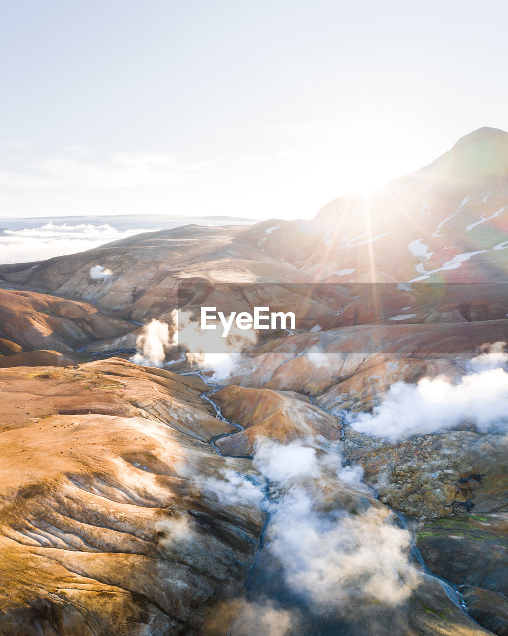SCENIC VIEW OF MOUNTAINS AGAINST BRIGHT SKY