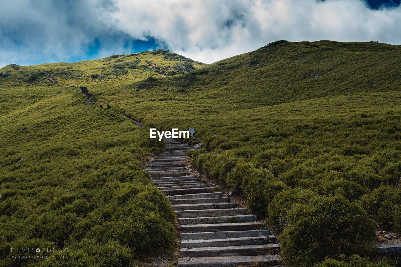 Scenic view of steps leading towards mountains against sky
