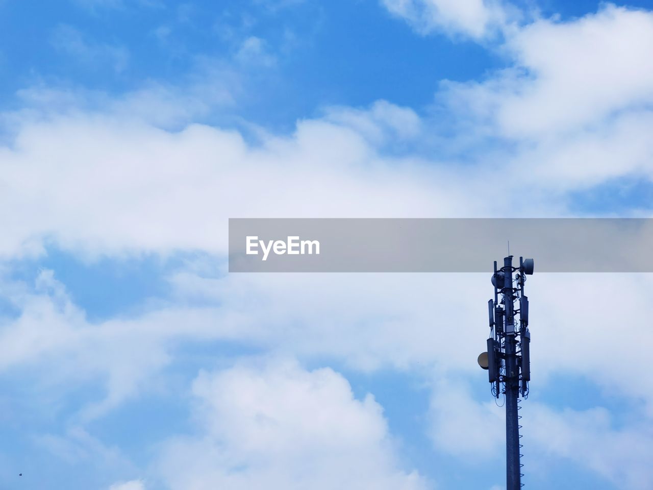 sky, blue, cloud, technology, broadcasting, low angle view, nature, no people, communication, tower, architecture, day, communications tower, electricity, outdoors, copy space, built structure, global communications, street light, wireless technology, telecommunications equipment, wind