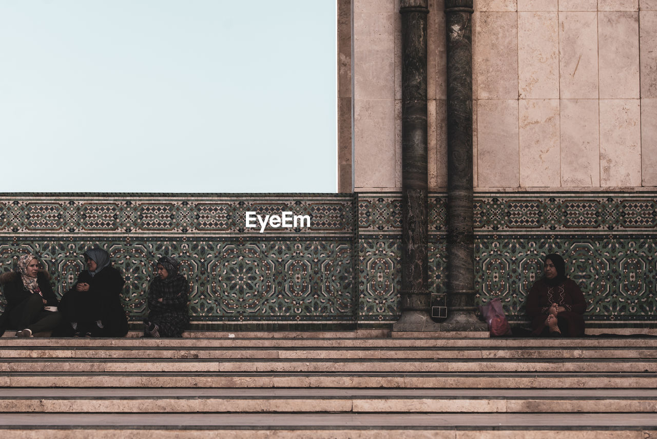 PEOPLE AT TEMPLE OUTSIDE BUILDING