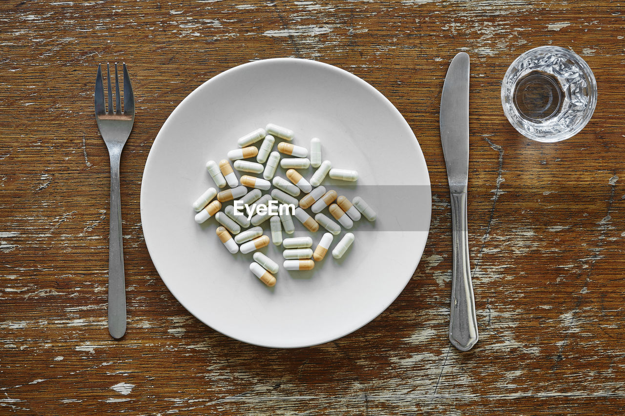 Directly above shot of capsules in plate on table