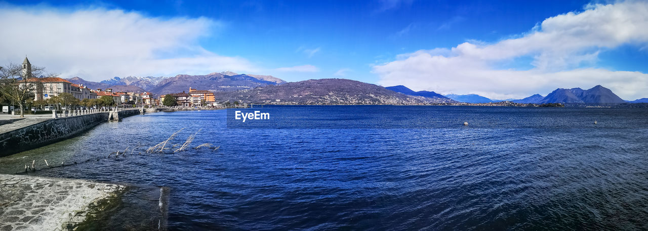 Panoramic view of sea by city against sky