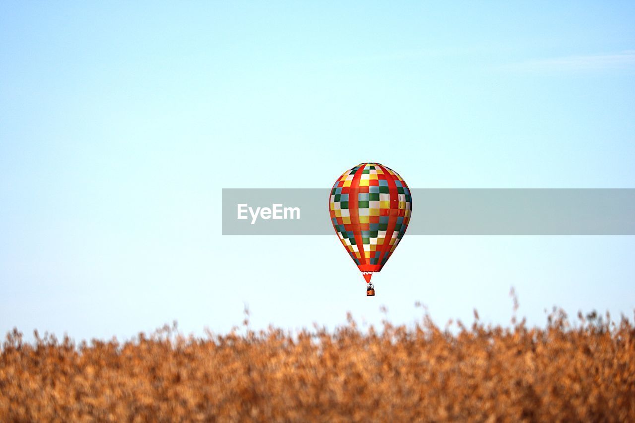VIEW OF HOT AIR BALLOON FLYING OVER LAND