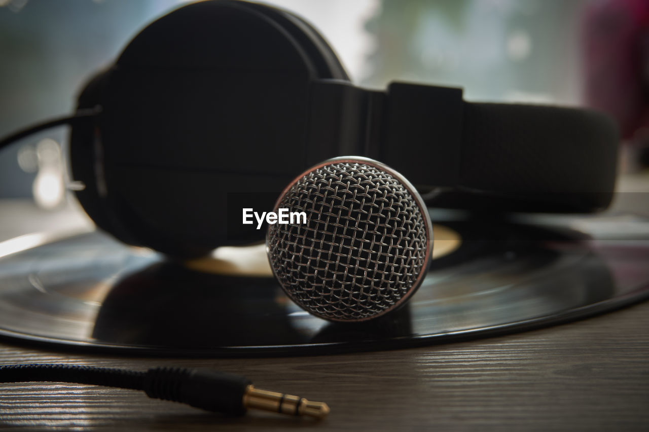 Close-up of microphone with headphones on table