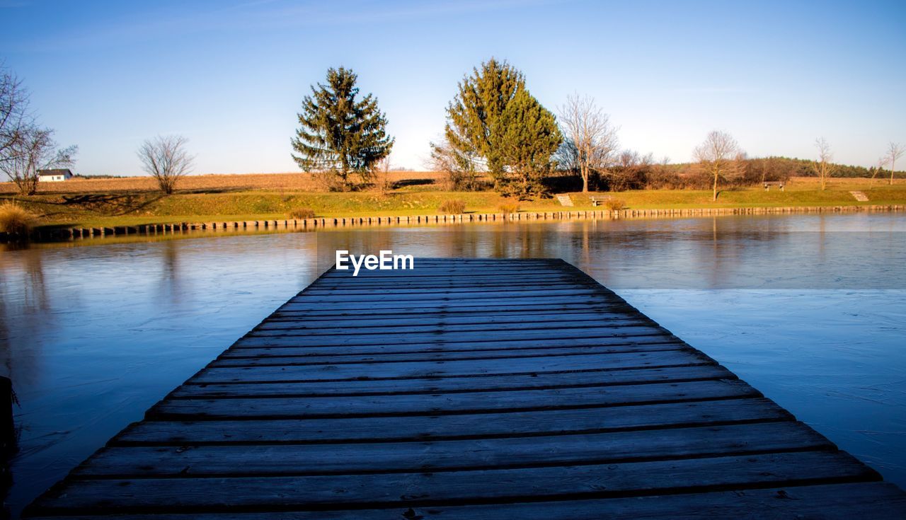 PIER ON LAKE AGAINST CLEAR SKY