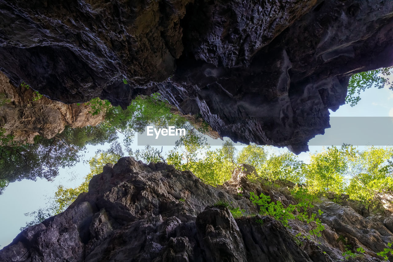 Deep gorge surrounded by millenary rocks, viewed from below.