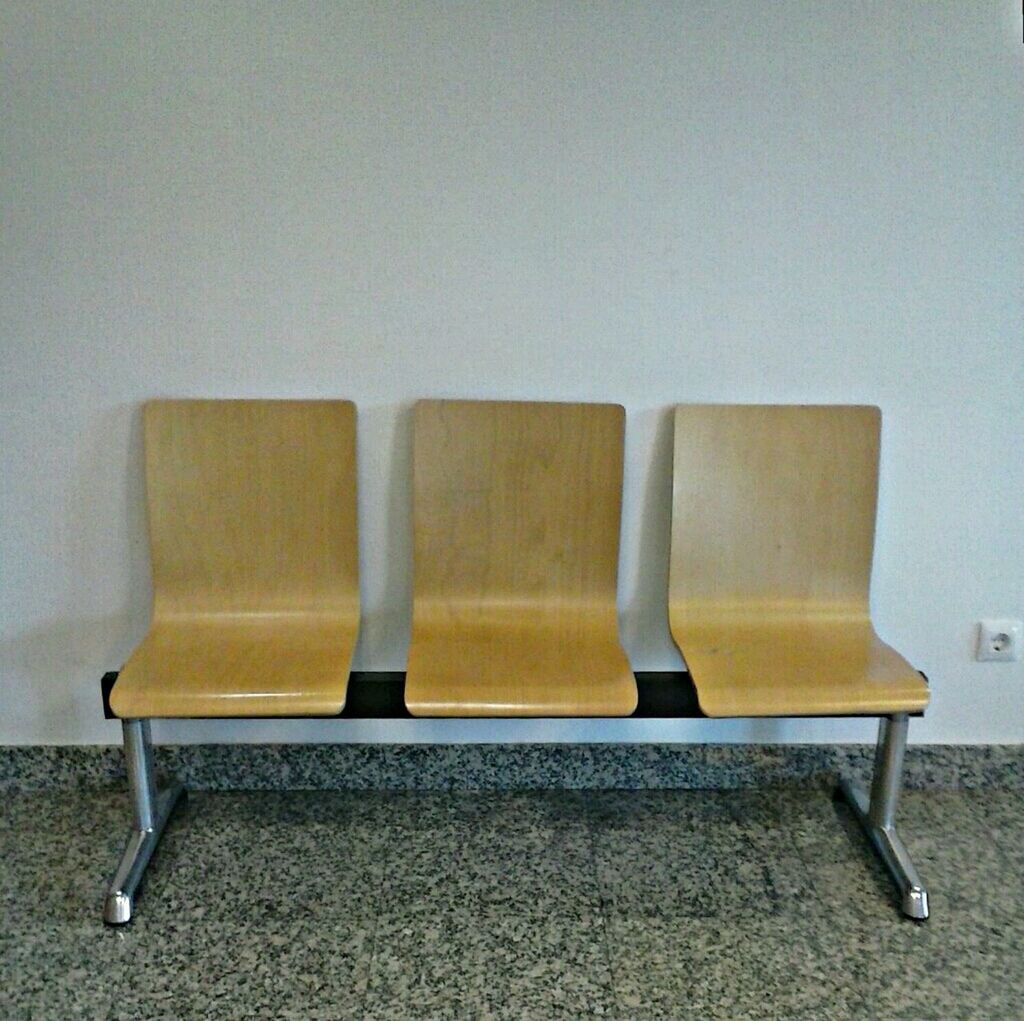 Empty chairs against the wall