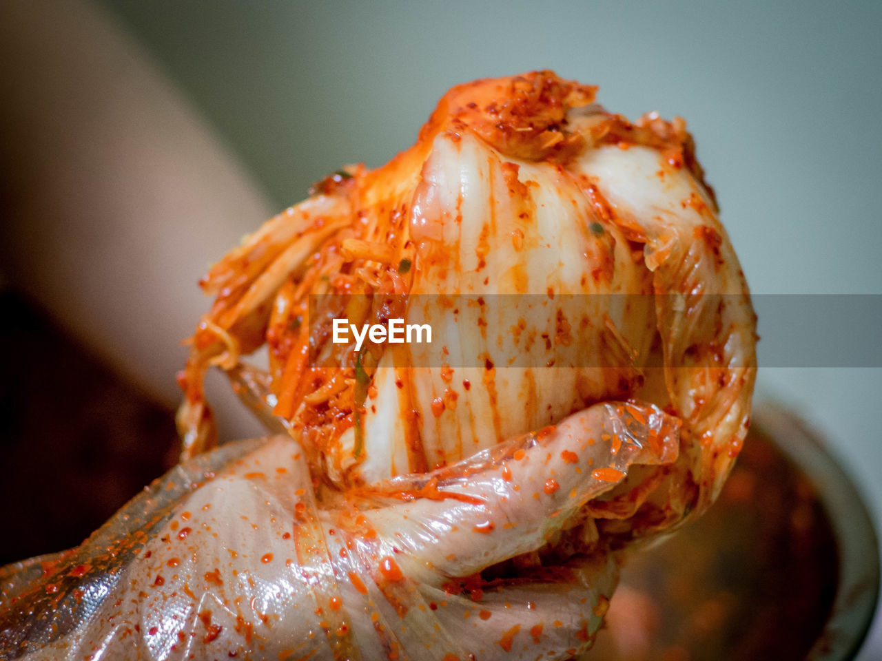 Cropped image of hands holding kimchi
