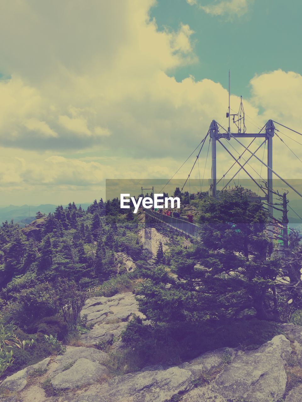 High angle view of people standing on bridge at grandfather mountain against sky